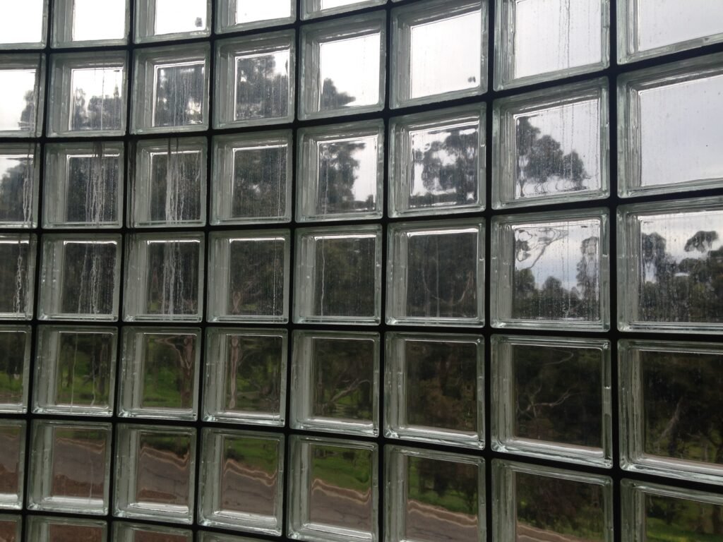 Glass-block stairwell window with trees visible through the glass